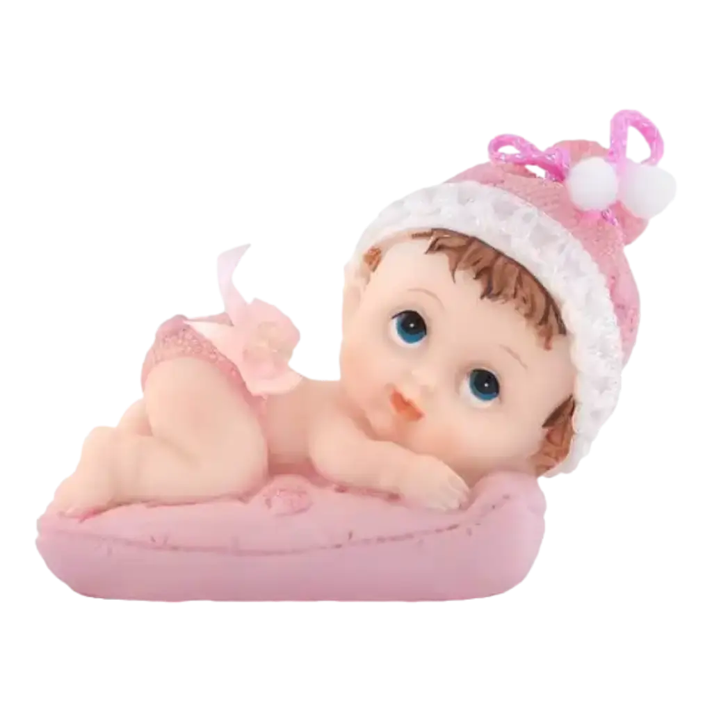 Figurita de bebé en un cojín rosa